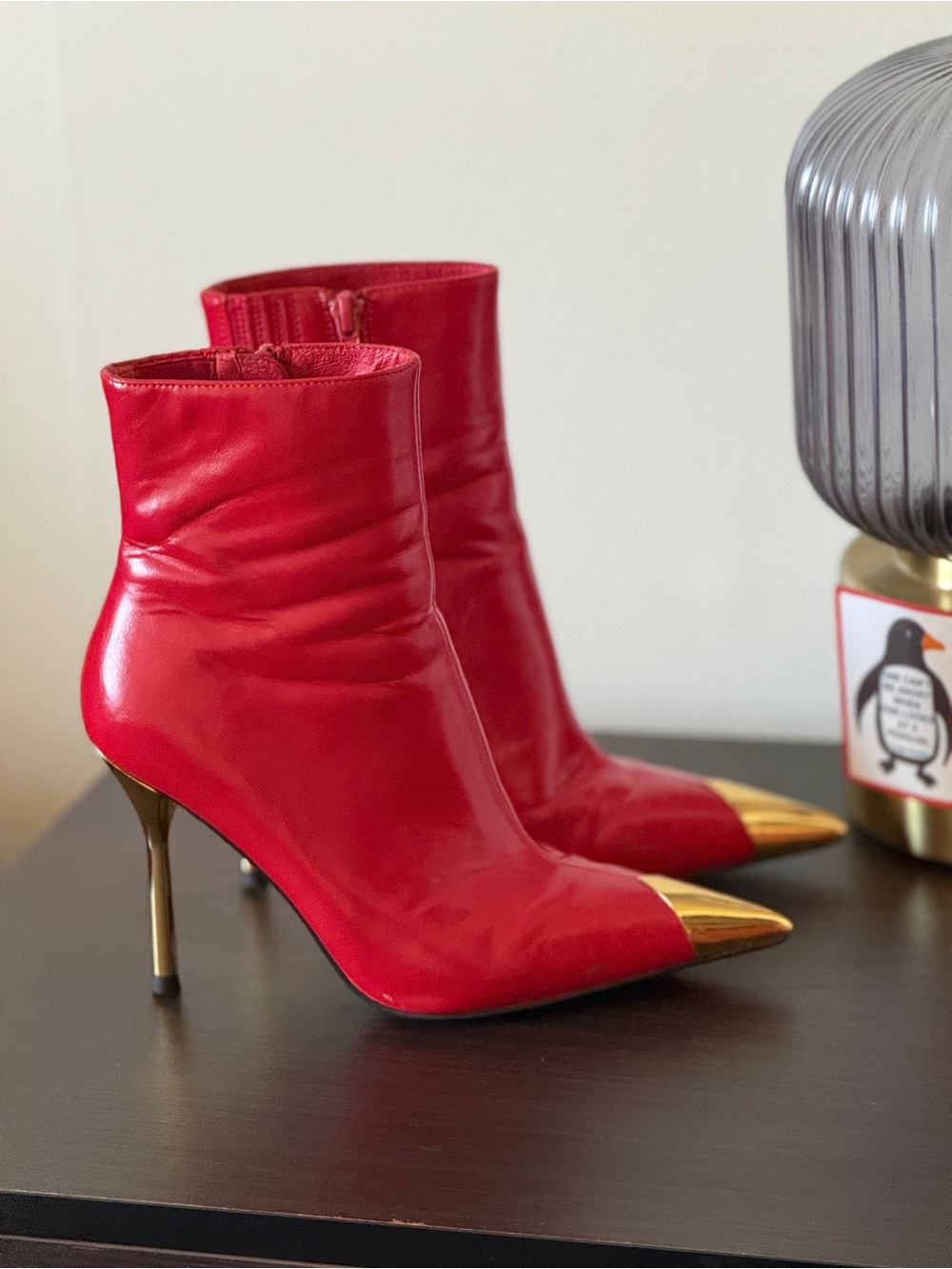 Red Leather Pointed-Toe Ankle Boots with Gold Toe and Heel.